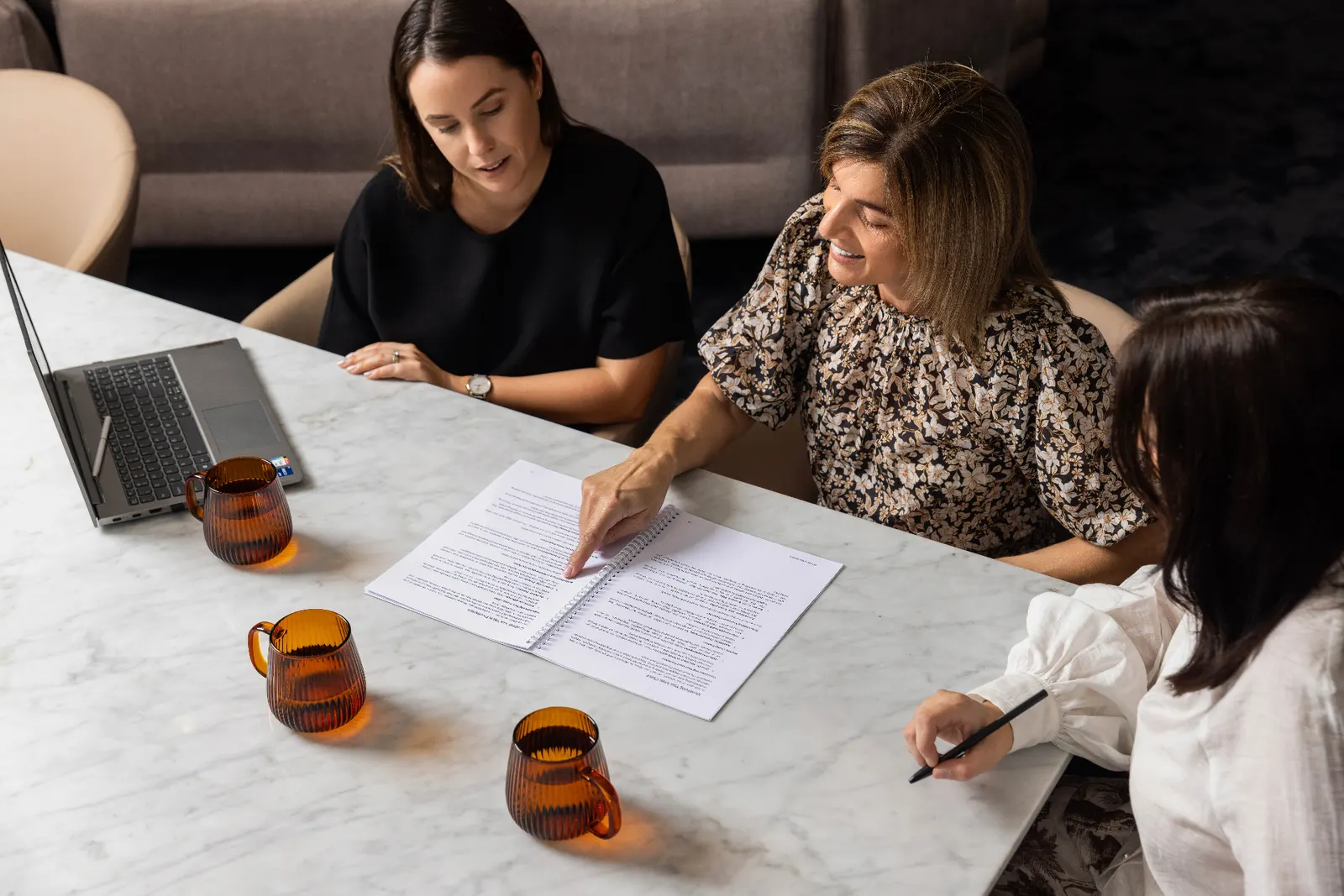 Wakefield Pacific advisers reviewing a planning document together at the office